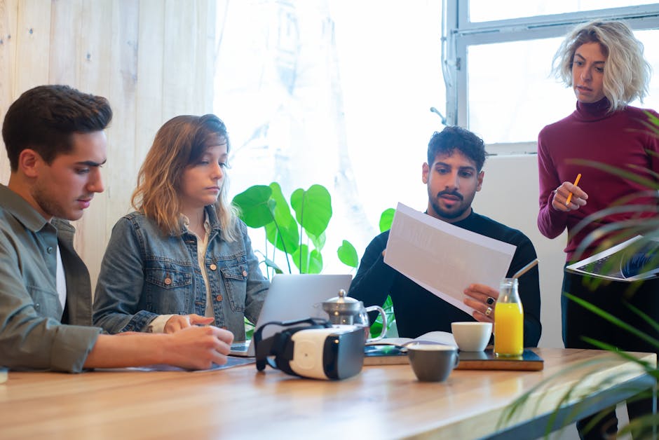 Group of young professionals collaborating in a modern, indoor office environment.